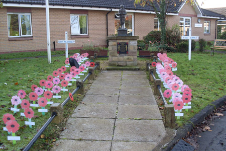 Decorative memorial filled with red poppies